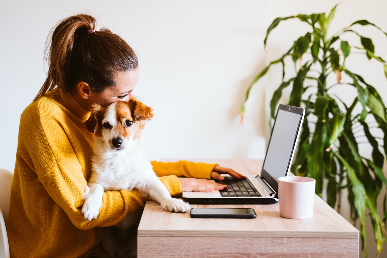 woman working at home with her dog